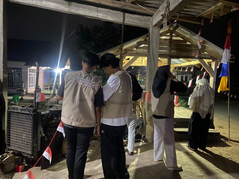 membantu warga memasang bendera untuk hut ri